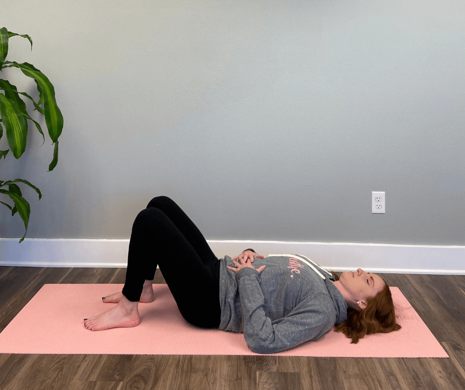 Woman lying on her yoga mat.